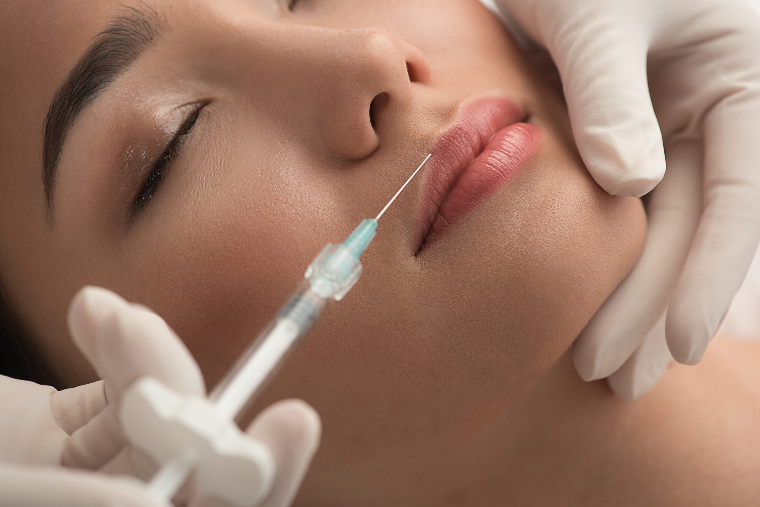 A woman undergoing lip treatment at a cosmetic surgery clinic.