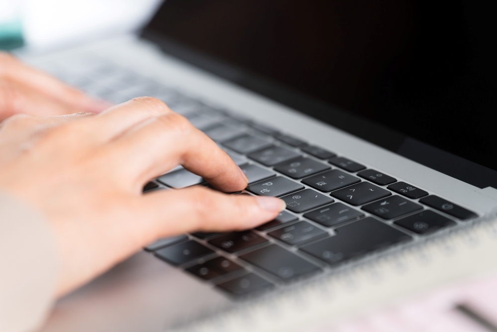 Hands searching for beauty-related information on a computer