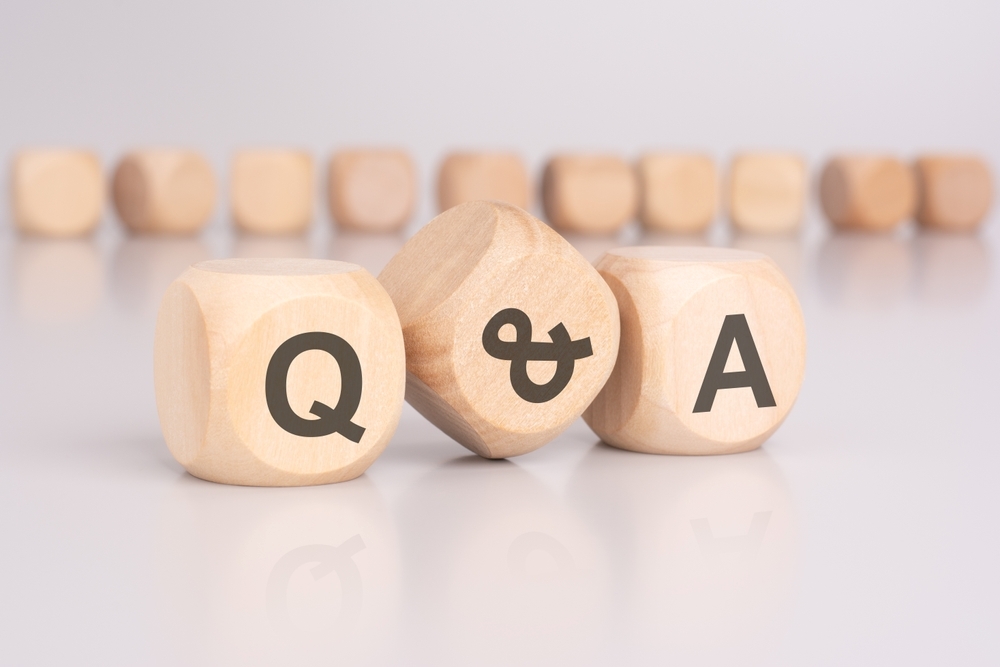 `alt="A wooden object with "Q&A" written on it."`