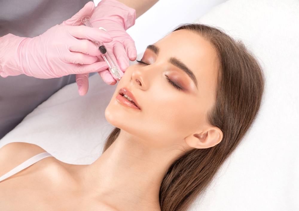 A woman undergoing Botox injections in her face