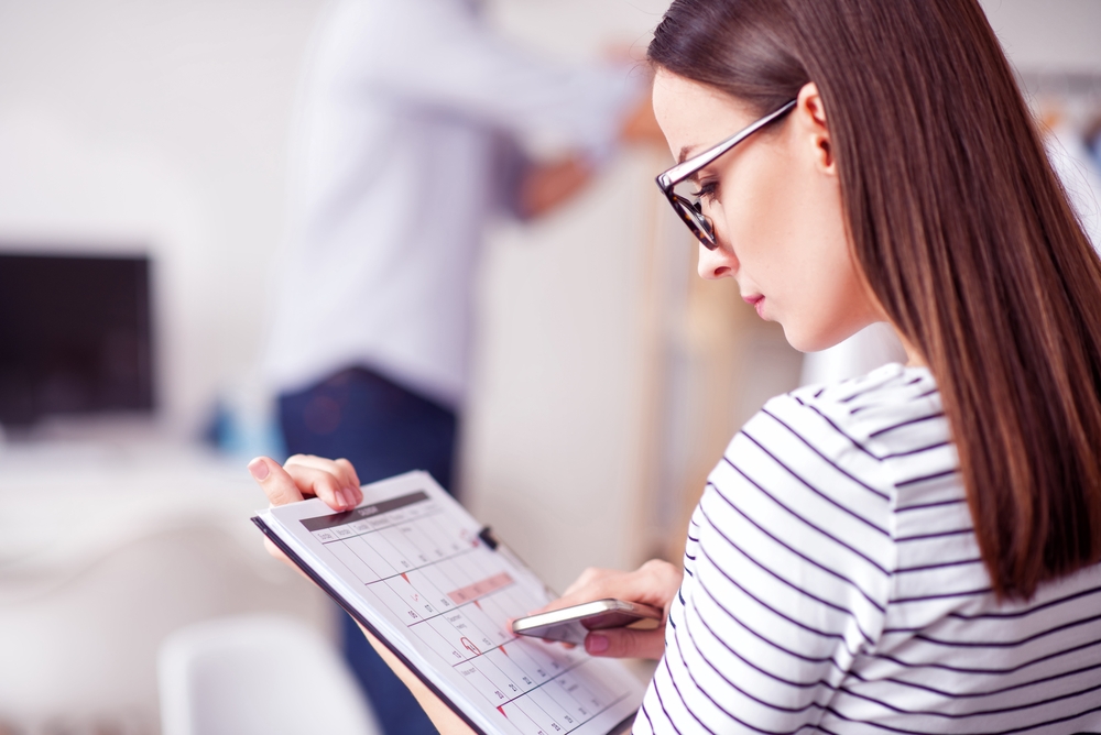 `alt="A woman considering scheduling a cosmetic dermatology appointment."`