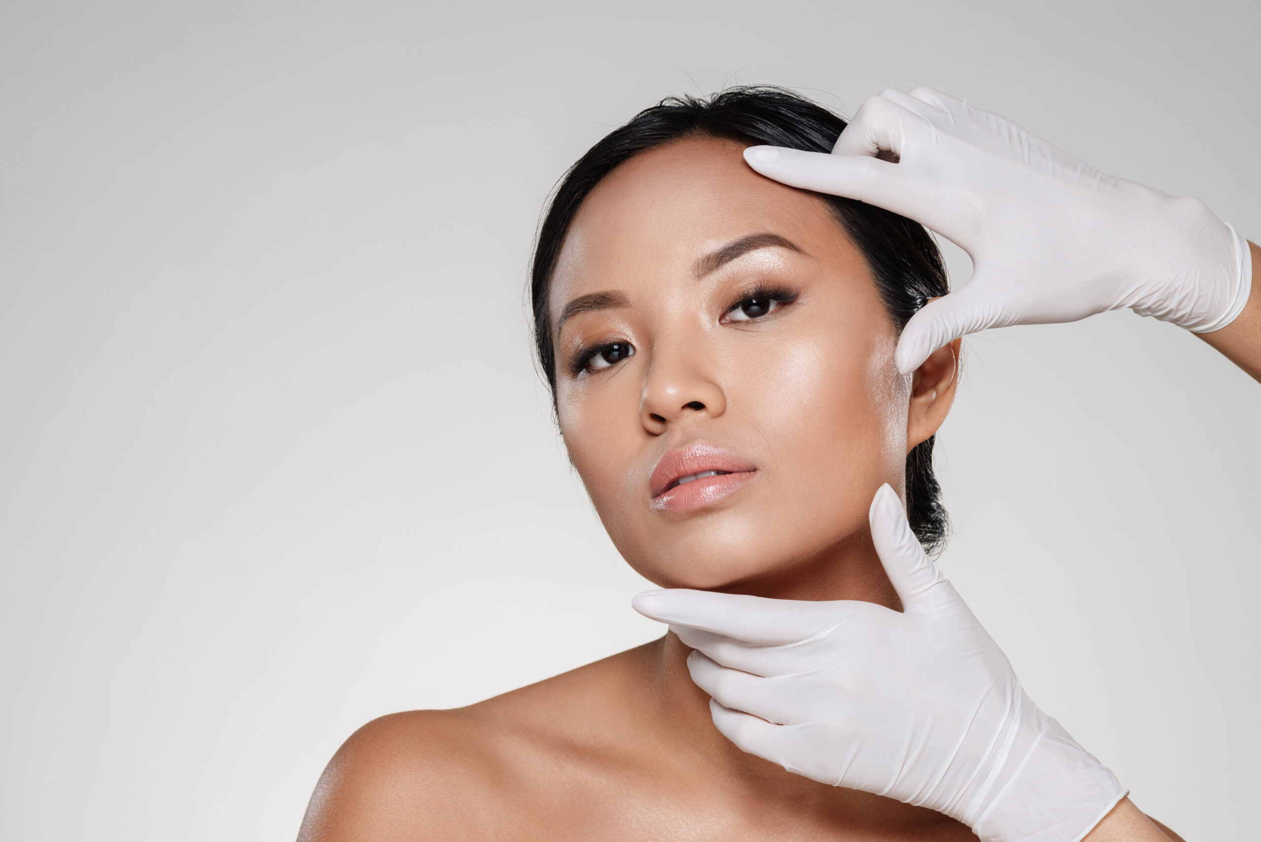 An Asian woman who is self-conscious about her prominent jawlines