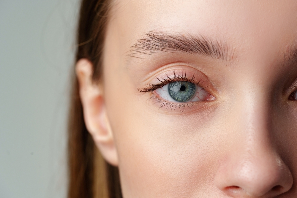 Front-facing close-up of a woman's upper and lower eyelids