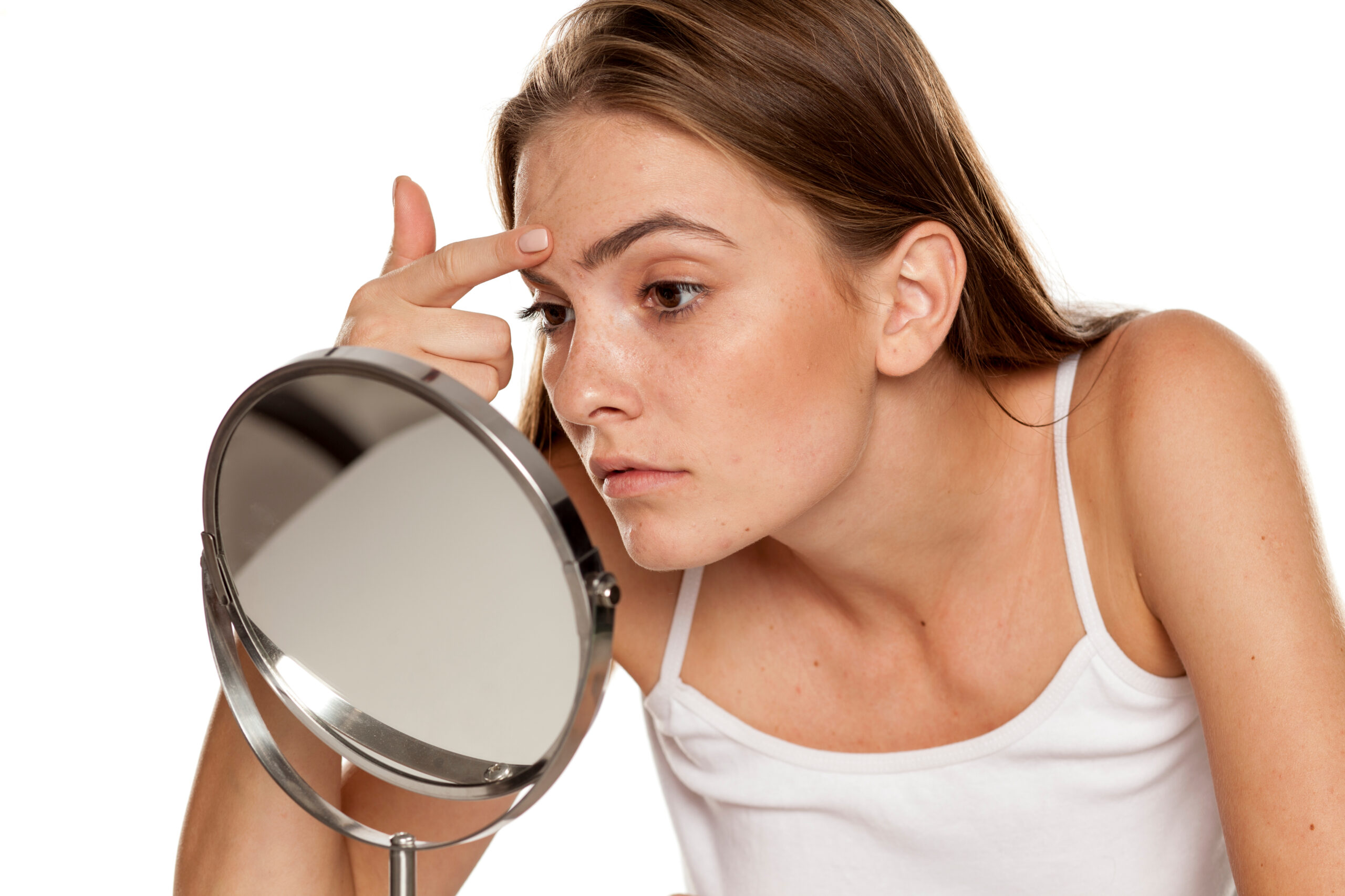 Woman looking in the mirror scaled