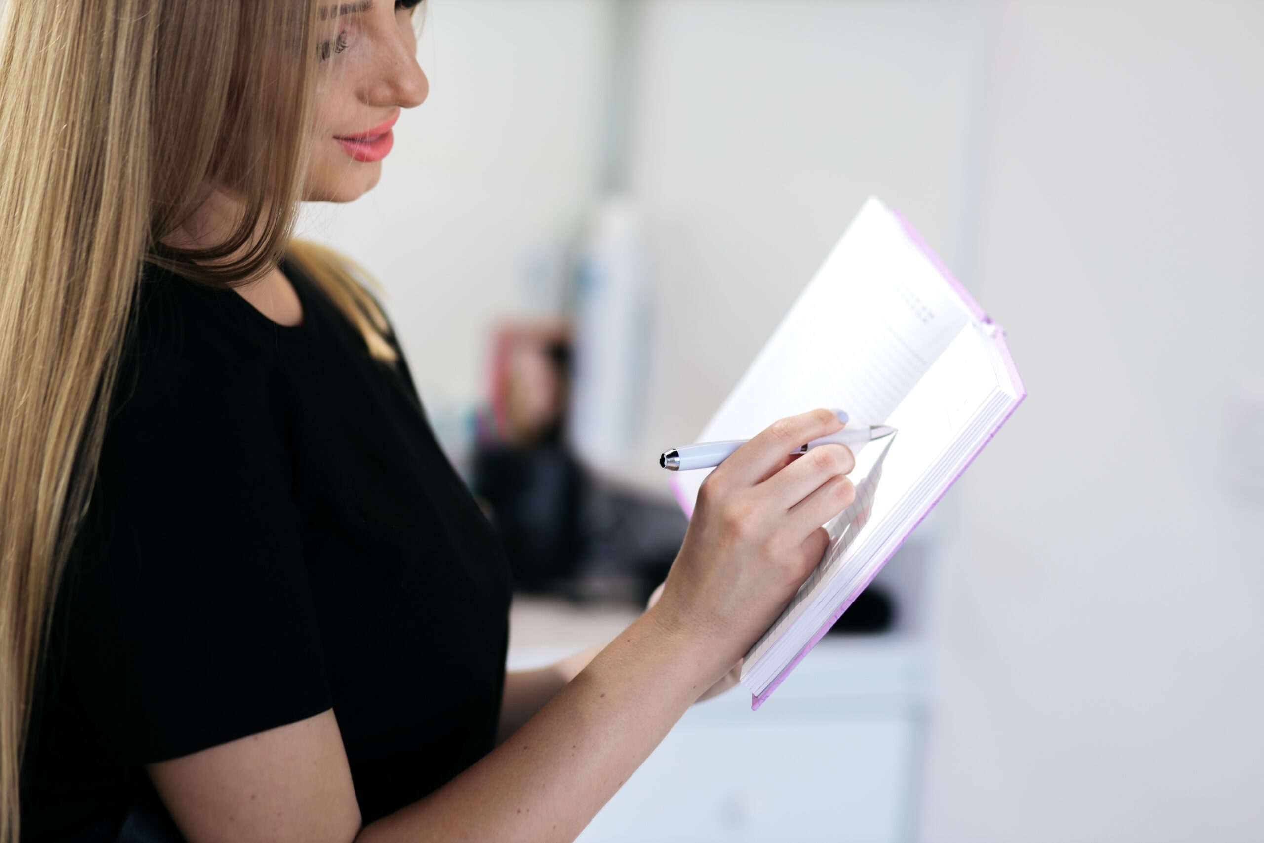 Woman taking notes during an aesthetic consultation
